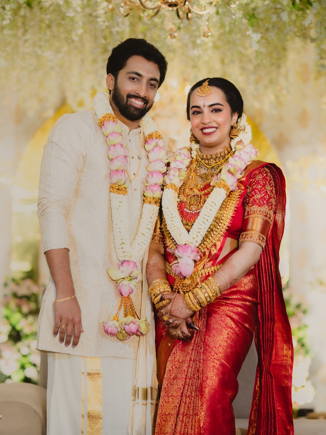 A couple seated together in traditional wedding attire