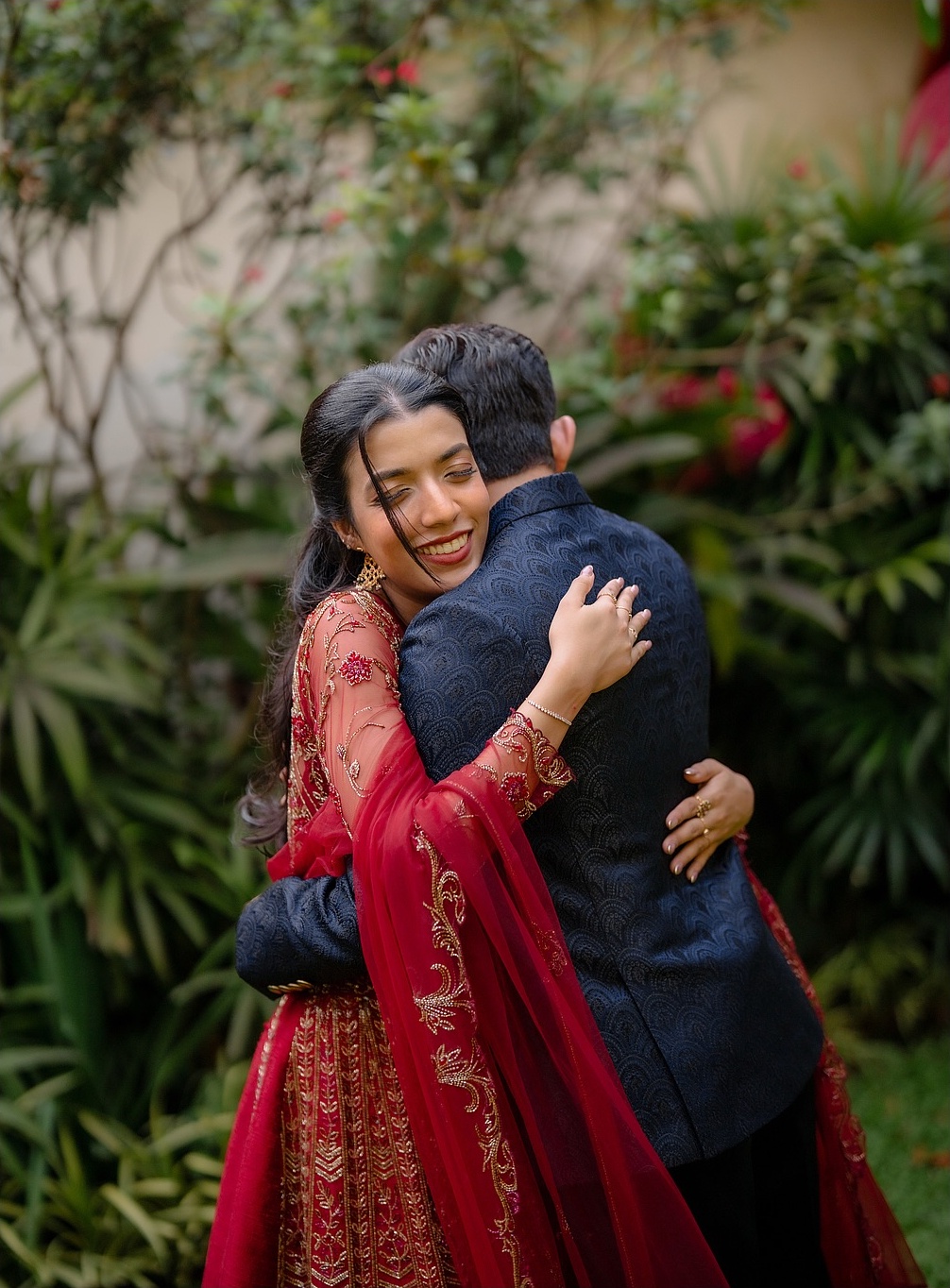 A couple sharing a joyful embrace in a garden